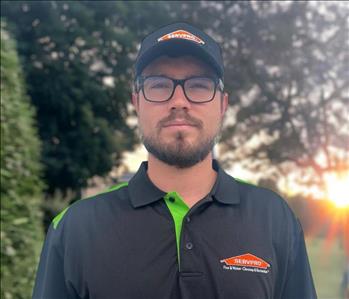 SERVPRO employee in front of outdoor background